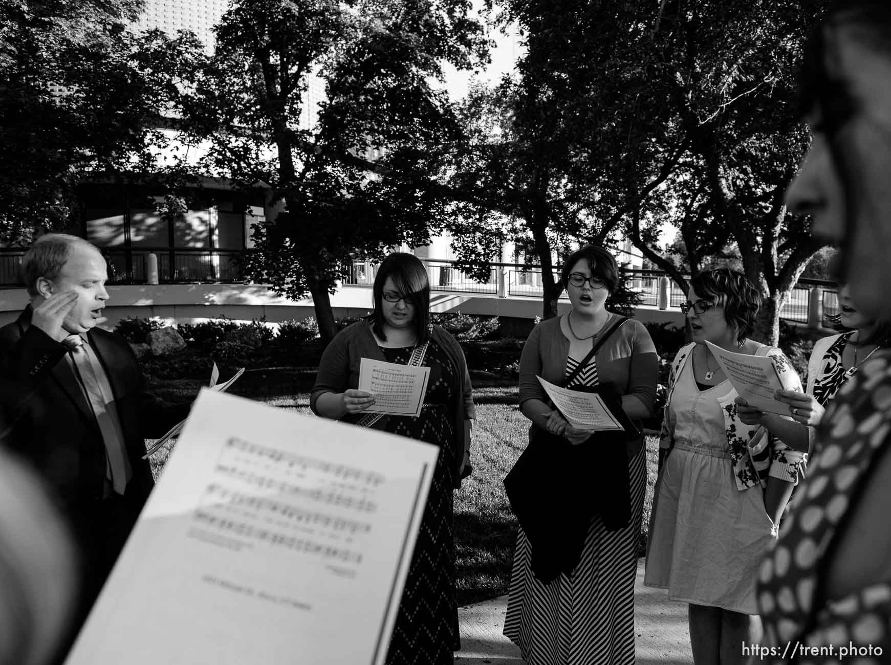 Trent Nelson  |  The Salt Lake Tribune
A group of people sing an LDS hymn before entering a broadcast of the LDS General Priesthood Session at BYU's Marriott Center in Provo Saturday October 4, 2014. The event was one of several planned by Ordain Women. Left to right, Zachary Noyce, Ellen Koester, Analisa Estrada, Cheryl Holdaway.