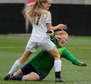 Trent Nelson  |  The Salt Lake Tribune
Desert Hills' Madelyn Hansen pushes past Cedar City goalkeeper Shay Bauman, nearly scoring as Cedar City faces Desert Hills in the 3A girls' high school soccer state championship game at Rio Tinto Stadium in Sandy, Saturday October 25, 2014.