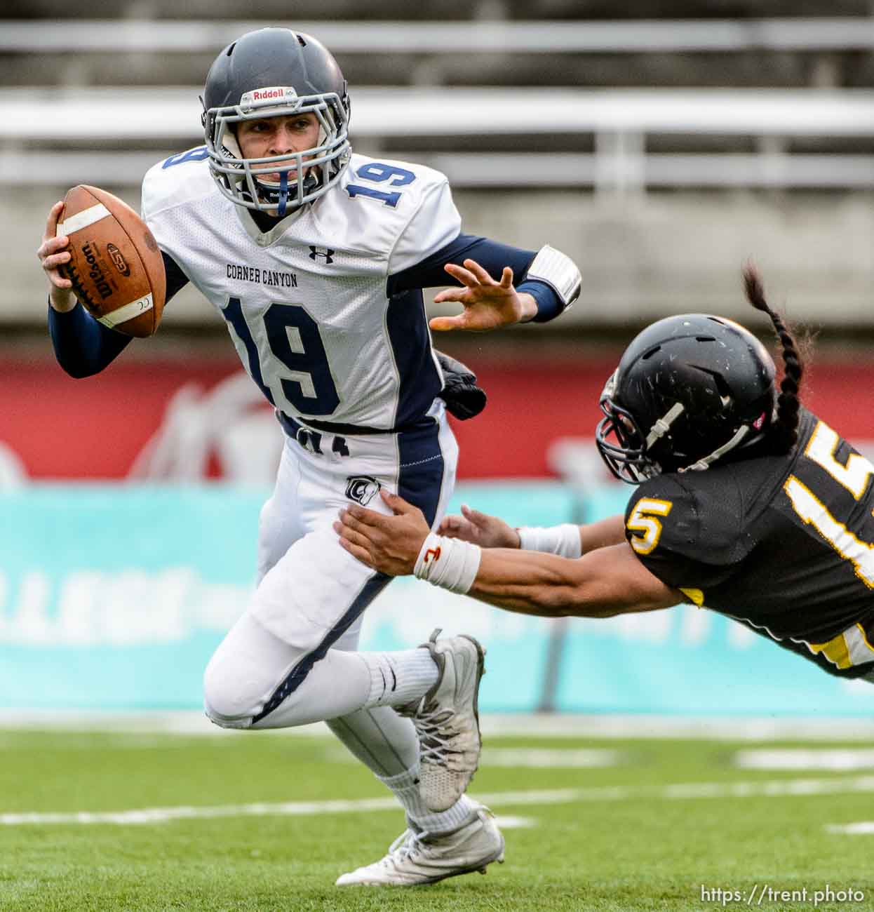 Trent Nelson  |  The Salt Lake Tribune
Corner Canyon's Kyle Reaveley runs from Roy's Baby Eteuati Corner Canyon faces Roy High School in a  4A state football semifinal game at Rice-Eccles Stadium in Salt Lake City, Friday November 14, 2014.