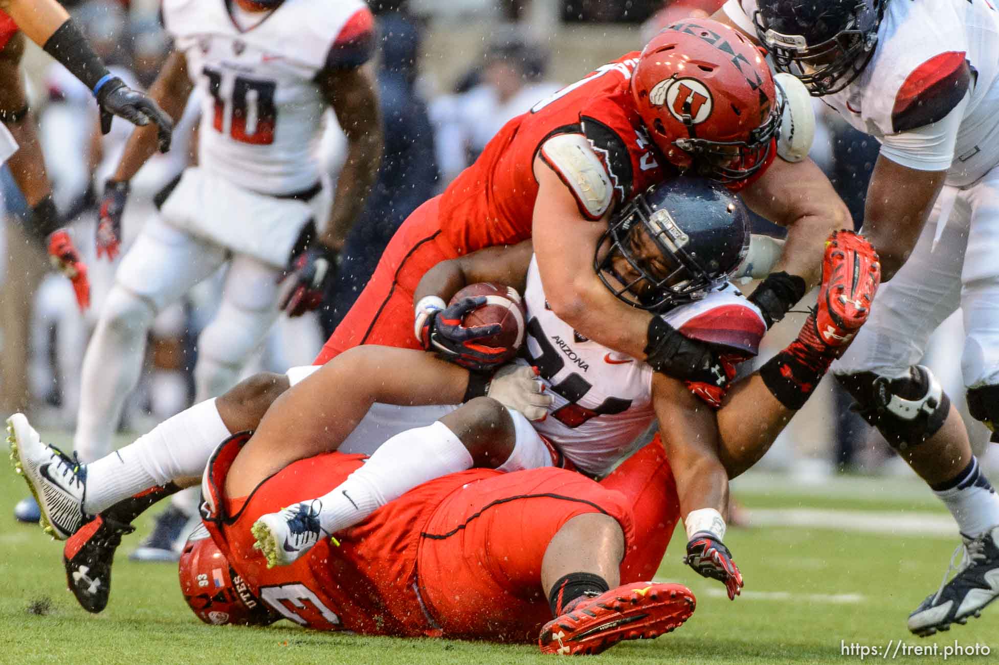 Trent Nelson  |  The Salt Lake Tribune
Arizona Wildcats running back Terris Jones-Grigsby (24) is brought down by Utah Utes defensive end Hunter Dimick (49) and defensive tackle Lowell Lotulelei (93) as the University of Utah Utes hosts the Arizona Wildcats, college football at Rice-Eccles Stadium in Salt Lake City Saturday November 22, 2014.