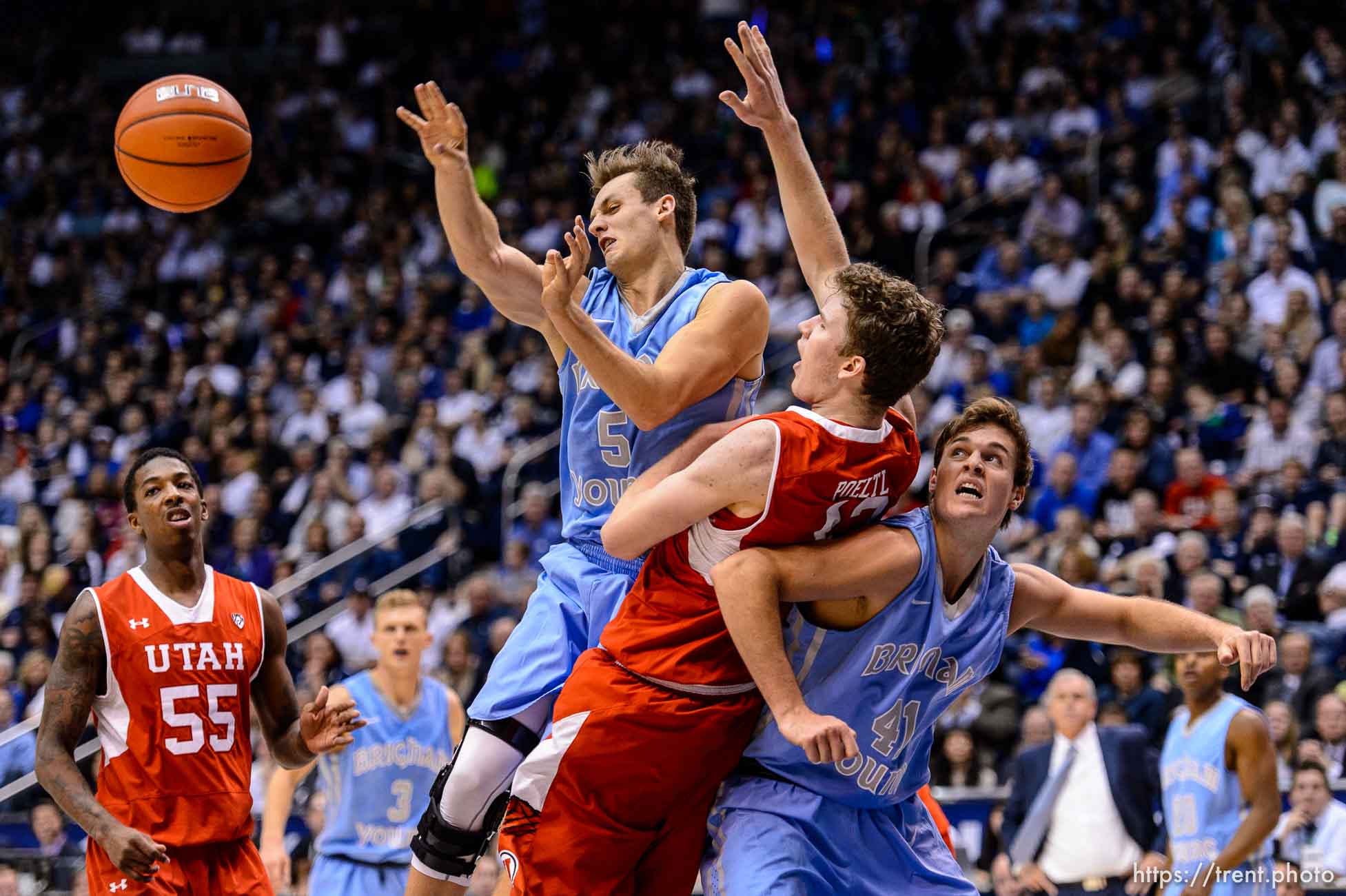 Trent Nelson  |  The Salt Lake Tribune
Brigham Young Cougars guard Kyle Collinsworth (5) passes the ball after colliding with Utah Utes forward Jakob Poeltl (42) as BYU hosts Utah, college basketball at the Marriott Center in Provo, Wednesday December 10, 2014. At left is Utah Utes guard Delon Wright (55), at right Brigham Young Cougars forward Luke Worthington (41).