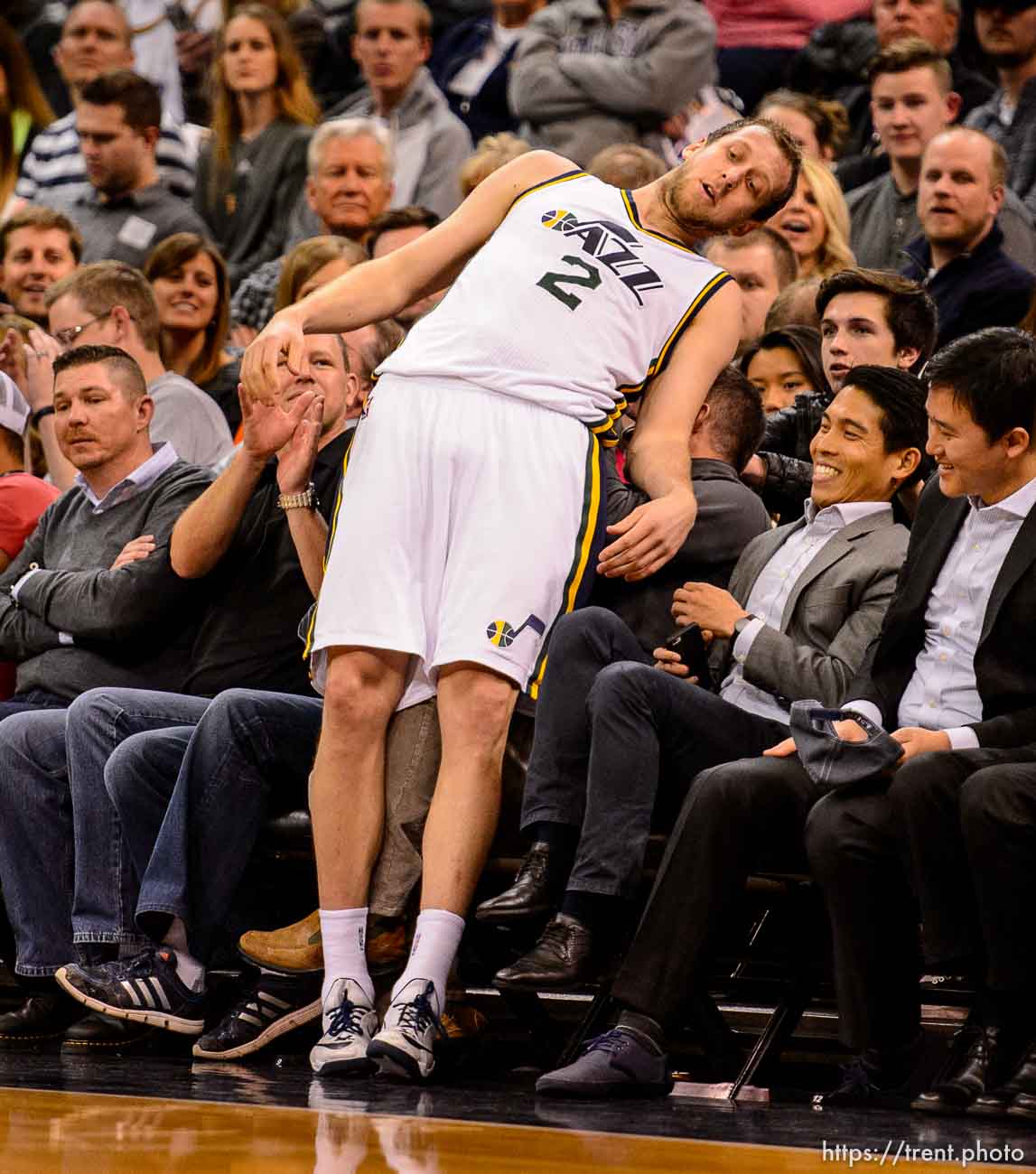 Utah Jazz forward Joe Ingles (2) falls into the crowd after chasing down a loose ball as the Utah Jazz host the Los Angeles Lakers at EnergySolutions Arena in Salt Lake City, Wednesday February 25, 2015.