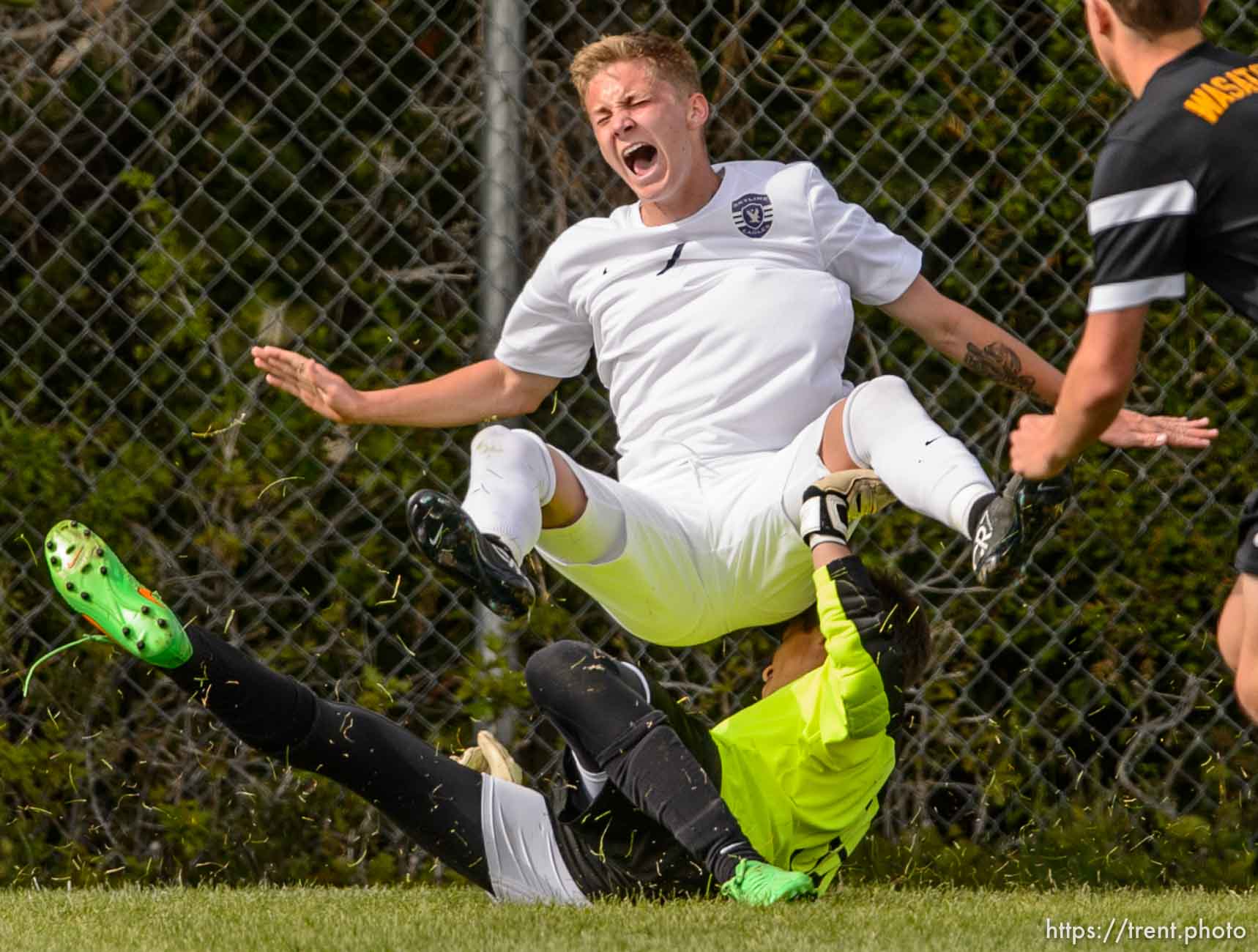 Trent Nelson  |  The Salt Lake Tribune
Wasatch's Charles Pennington (33) fouls Skyline's Hunter Kone (7), resulting in a yellow card, penalty kick, and Skyline goal during a first round Class 4A soccer state game between Wasatch and Skyline High School, in Salt Lake City, Wednesday May 13, 2015.