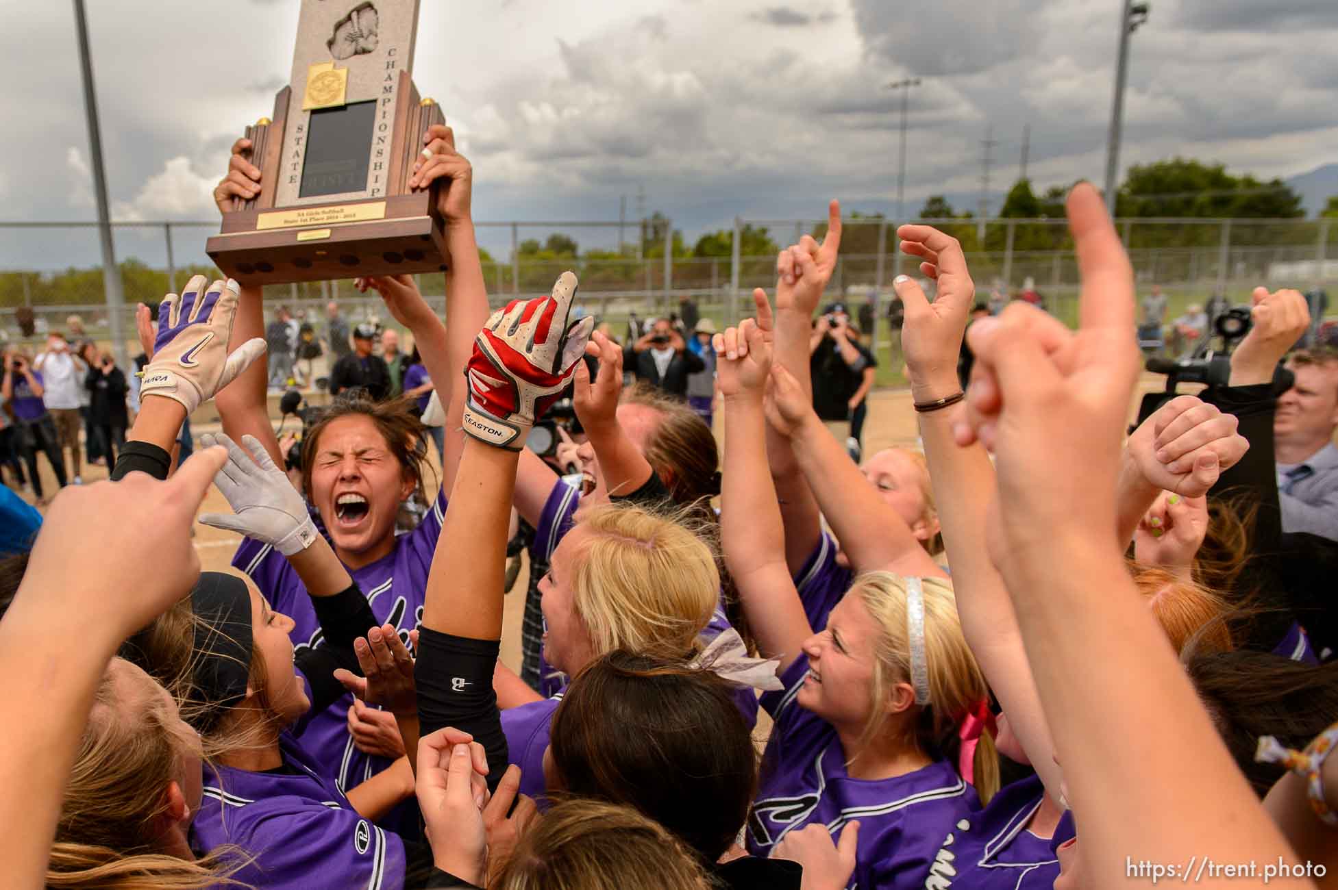 Trent Nelson  |  The Salt Lake Tribune
Lehi player celebrate after beating Herriman in the 5A high school softball championship game, in West Valley City, Friday May 22, 2015. Holding the trophy is Terra Tahbo.