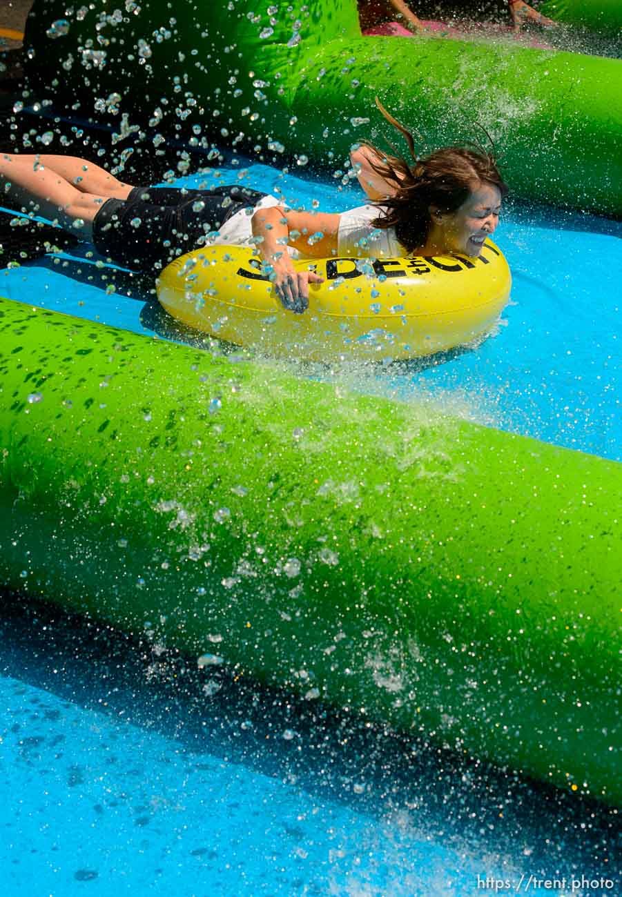 Trent Nelson  |  The Salt Lake Tribune
A rider slides down Main Street on a massive slip 'n slide put up by Slide the City, in Salt Lake City, Saturday August 22, 2015.