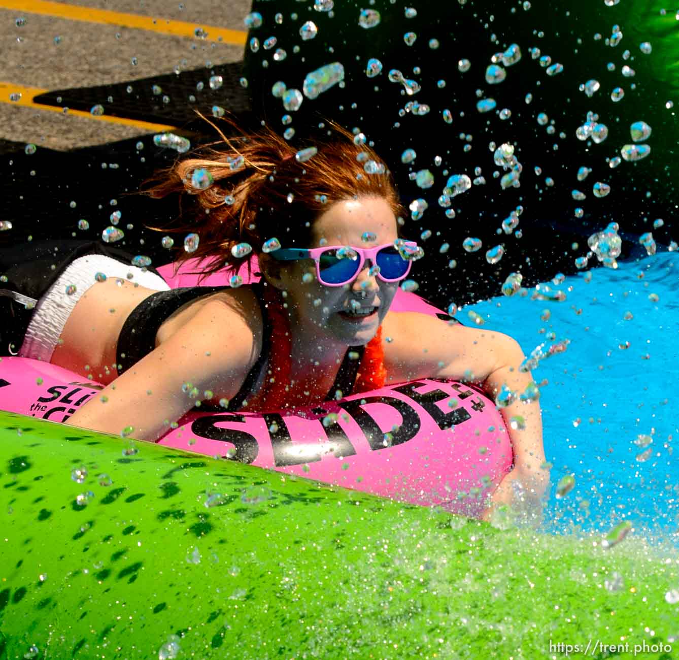 Trent Nelson  |  The Salt Lake Tribune
A rider slides down Main Street on a massive slip 'n slide put up by Slide the City, in Salt Lake City, Saturday August 22, 2015.