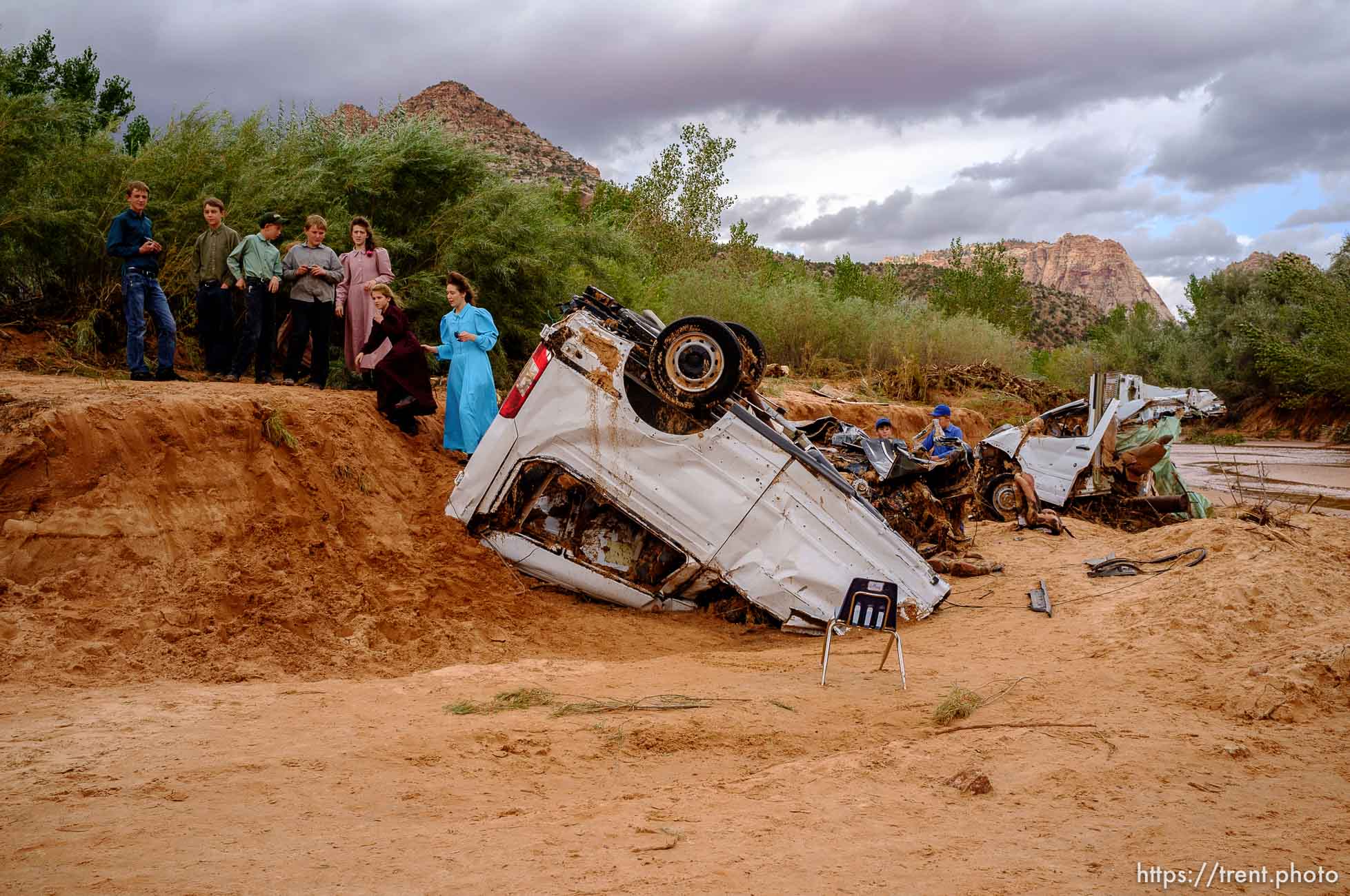 Trent Nelson  |  The Salt Lake Tribune
People take in the scene in a Hildale wash where two vehicles came to rest after a flash flood that killed nine people (with four still missing) Tuesday September 15, 2015., the day after an SUV and a van were washed off a road during a flash flood in this polygamous Utah-Arizona border community.