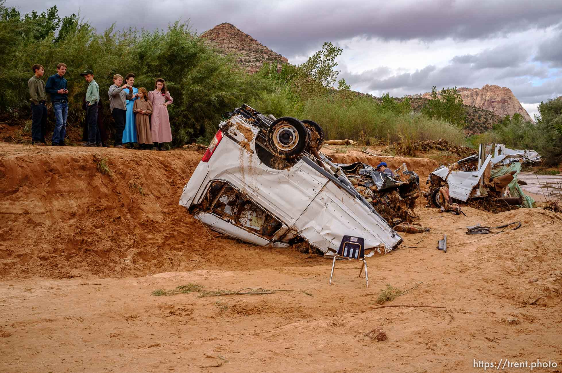 Trent Nelson  |  The Salt Lake Tribune
People take in the scene in a Hildale wash where two vehicles came to rest after a flash flood that killed nine people (with four still missing) Tuesday September 15, 2015., the day after an SUV and a van were washed off a road during a flash flood in this polygamous Utah-Arizona border community.