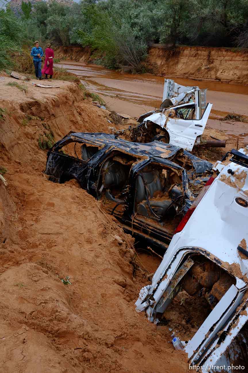 Trent Nelson  |  The Salt Lake Tribune
People take in the scene in a Hildale wash where two vehicles came to rest after a flash flood that killed nine people (with four still missing) Tuesday September 15, 2015., the day after an SUV and a van were washed off a road during a flash flood in this polygamous Utah-Arizona border community.