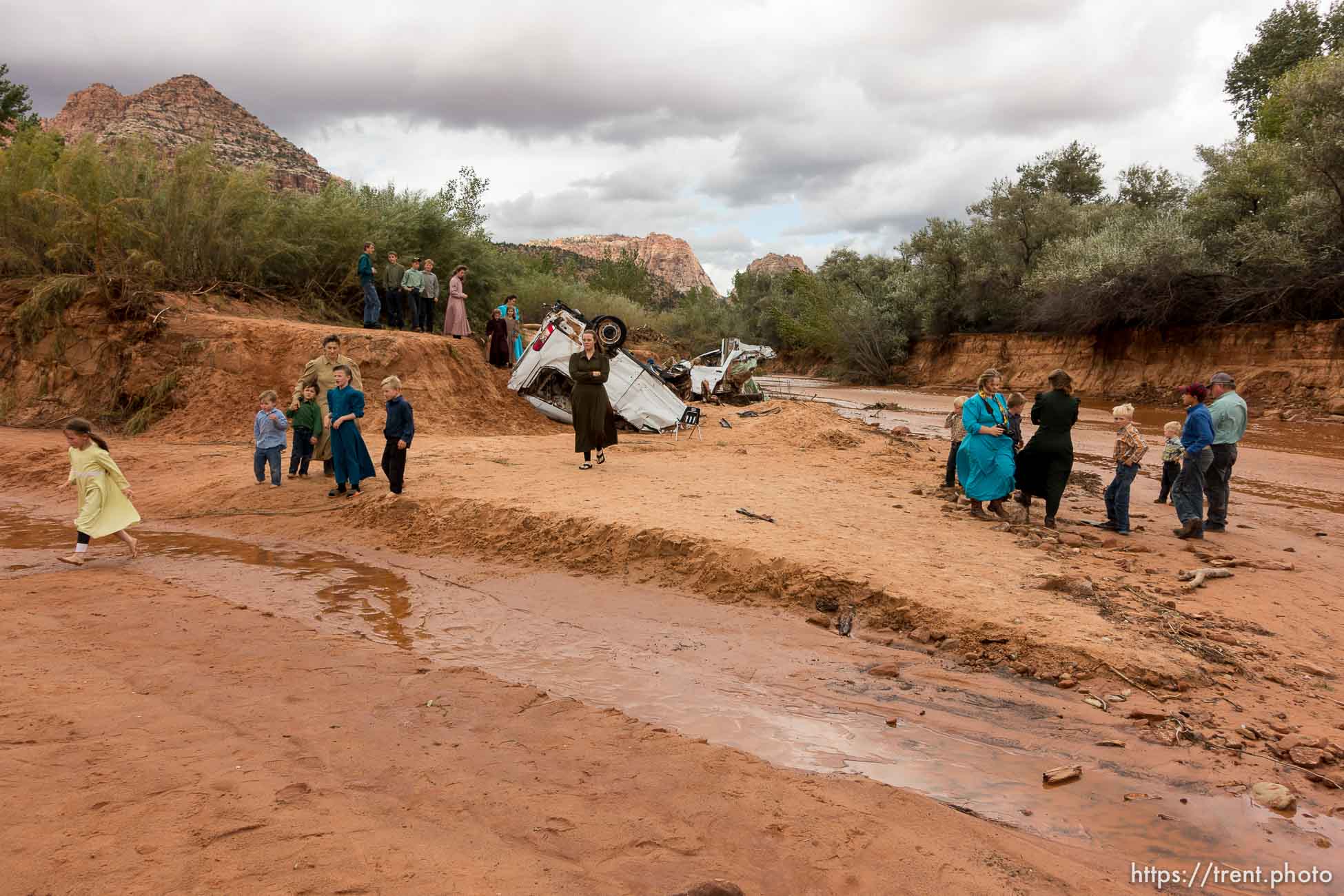 Trent Nelson  |  The Salt Lake Tribune
People at the spot in a Hildale wash Tuesday September 15, 2015 where two vehicles ended up after being washed away in a flash flood. Nine people died (with four still missing) when the SUV and van were washed off a road during a flash flood in this polygamous Utah-Arizona border community.