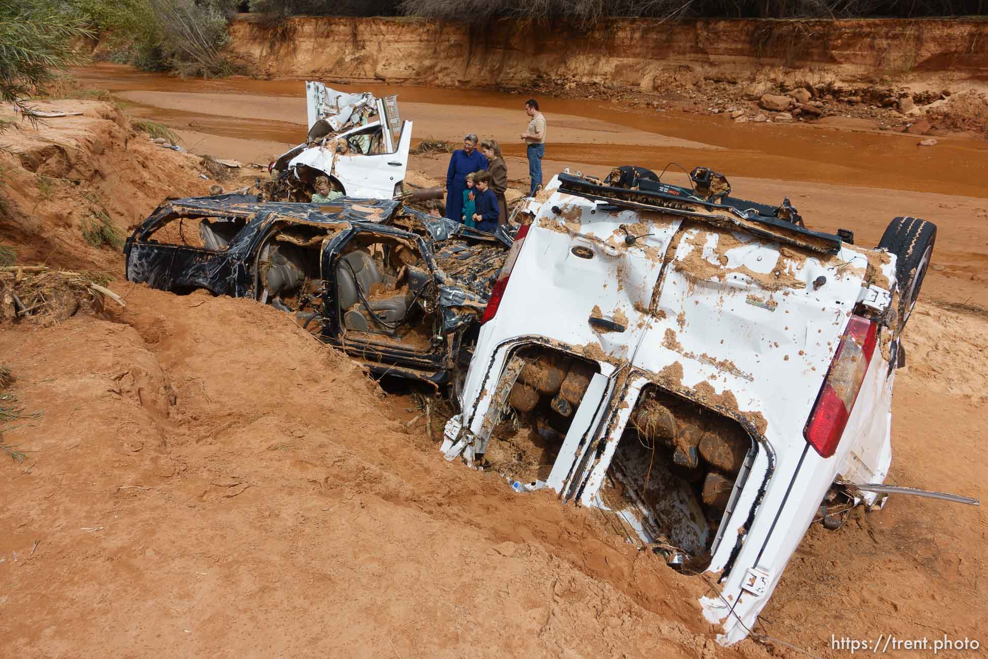 Trent Nelson  |  The Salt Lake Tribune
People at the spot in a Hildale wash Tuesday September 15, 2015 where two vehicles ended up after being washed away in a flash flood. Nine people died (with four still missing) when the SUV and van were washed off a road during a flash flood in this polygamous Utah-Arizona border community.