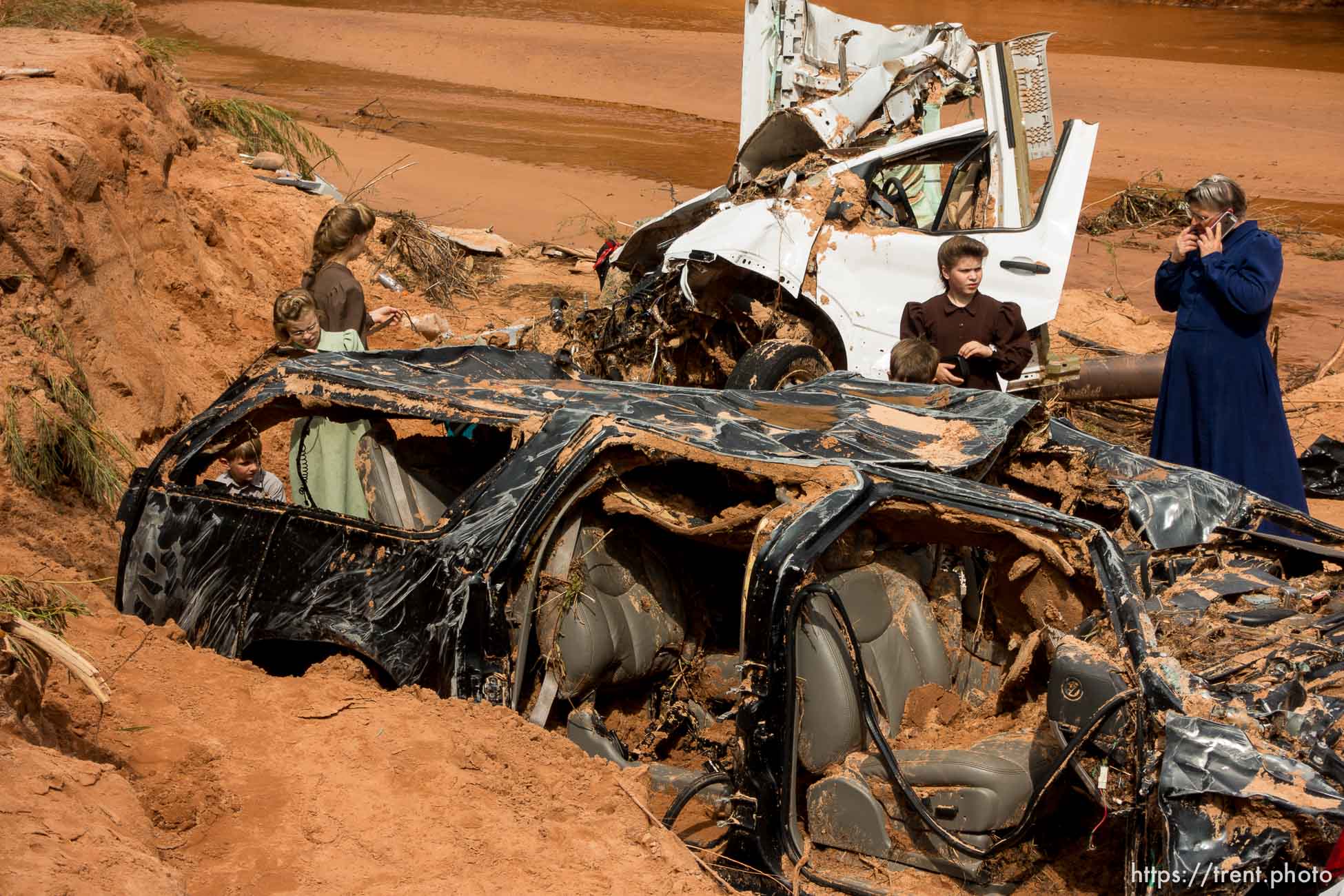 Trent Nelson  |  The Salt Lake Tribune
People at the spot in a Hildale wash Tuesday September 15, 2015 where two vehicles ended up after being washed away in a flash flood. Nine people died (with four still missing) when the SUV and van were washed off a road during a flash flood in this polygamous Utah-Arizona border community.