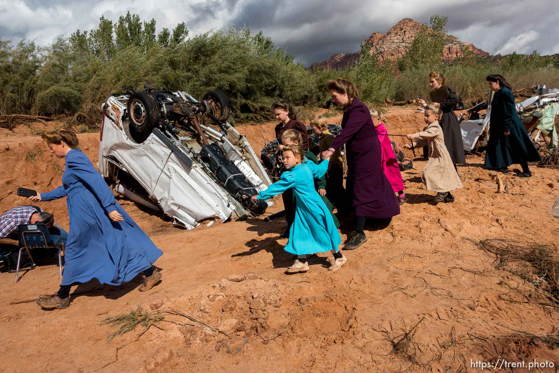 Trent Nelson  |  The Salt Lake TribuneA group of FLDS women quickly leave the scene of a flash flood incident as a TV cameraman begins filming, Wednesday September 16, 2015.