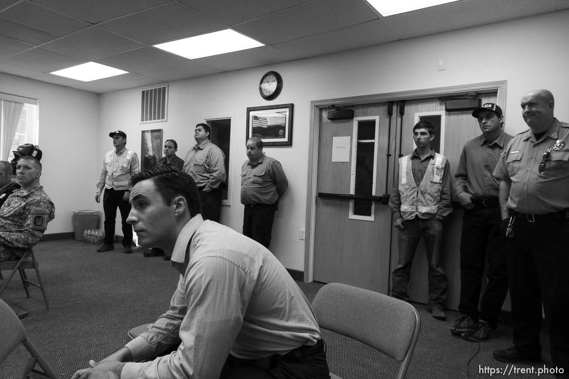 Trent Nelson  |  The Salt Lake Tribune
FLDS looking on as Hildale Mayor Phillip Barlow speaks at a press conference regarding the continued search after a flash flood. Colorado City, Wednesday September 16, 2015. 
first four from left: david darger, sheldon black, marcus jeffs, curtis cook - marshal. at far right is Washington County Sheriff Cory Pulsipher and at his left is jerry darger chief of police (blk cap).