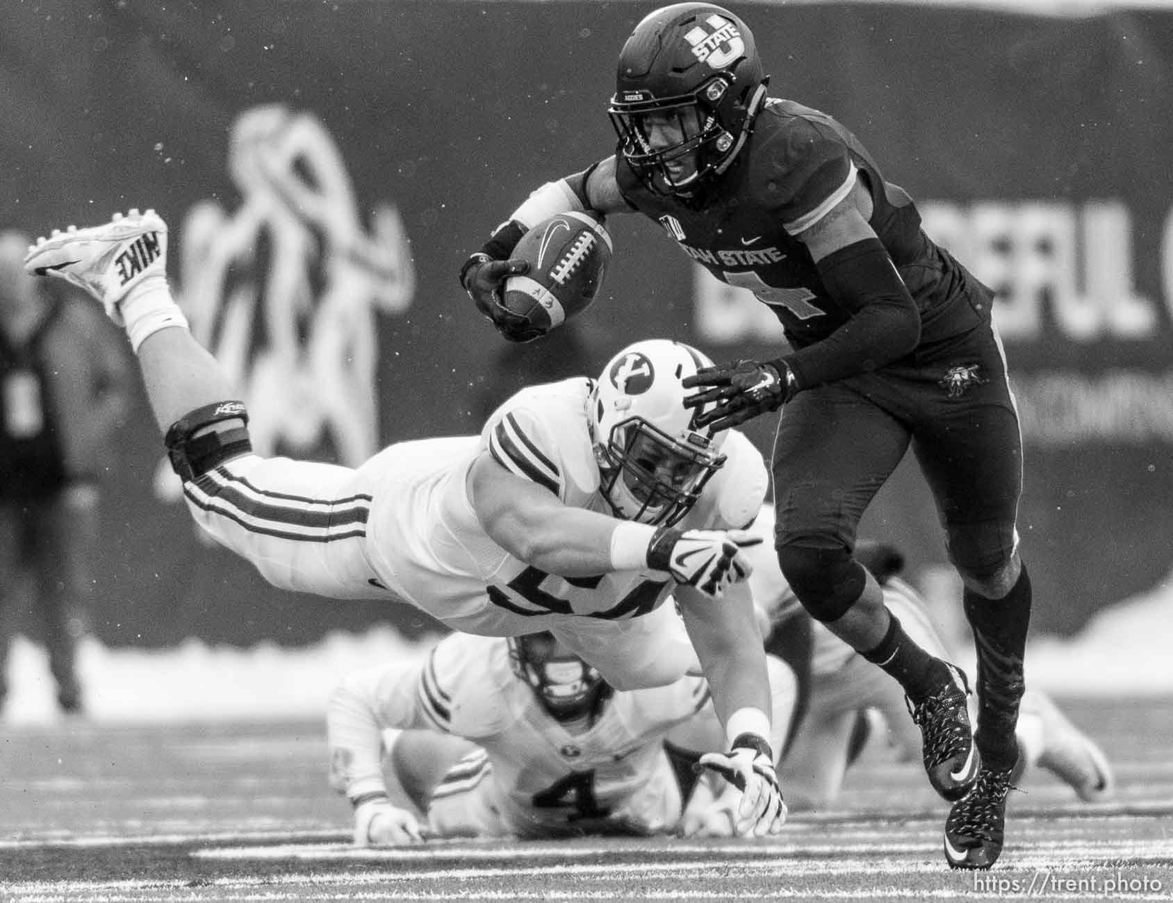 Trent Nelson  |  The Salt Lake Tribune
Brigham Young Cougars offensive lineman Parker Dawe (54) dives after Utah State Aggies wide receiver Hunter Sharp (4) as Utah State hosts BYU, NCAA football in Logan, Saturday November 28, 2015.