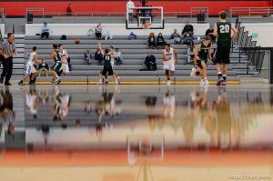 Trent Nelson  |  The Salt Lake Tribune
Reflections on the court as Bingham plays Olympus in the first round of the boys' basketball Elite 8 Tournament at American Fork High School, Thursday December 10, 2015.