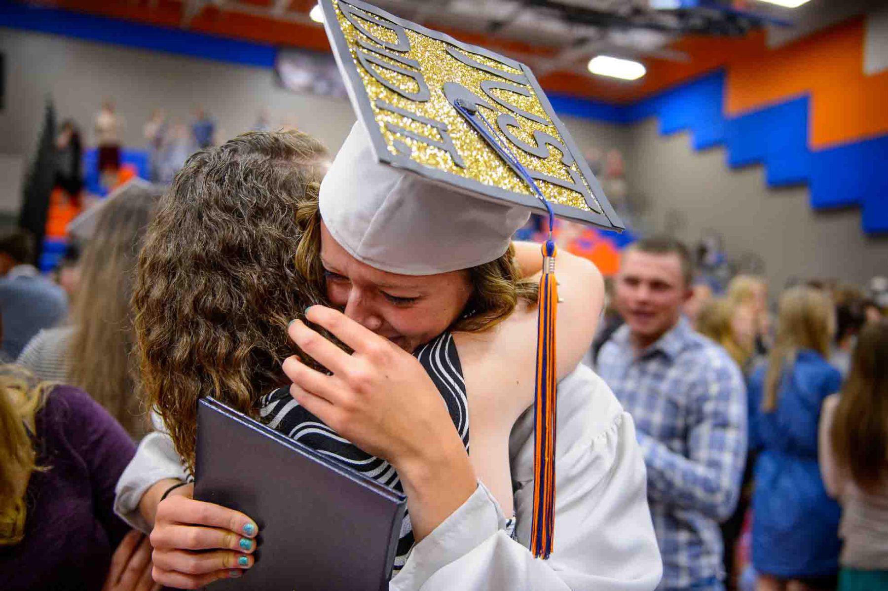 Trent Nelson  |  The Salt Lake Tribune
Water Canyon High School graduate Danielle Barlow breaks down in tears in the arm of a friend, Paula Barlow, after a graduation ceremony in Hildale, Monday May 22, 2017. Barlow is the 13th of 16 children, and the first to earn a high school diploma.