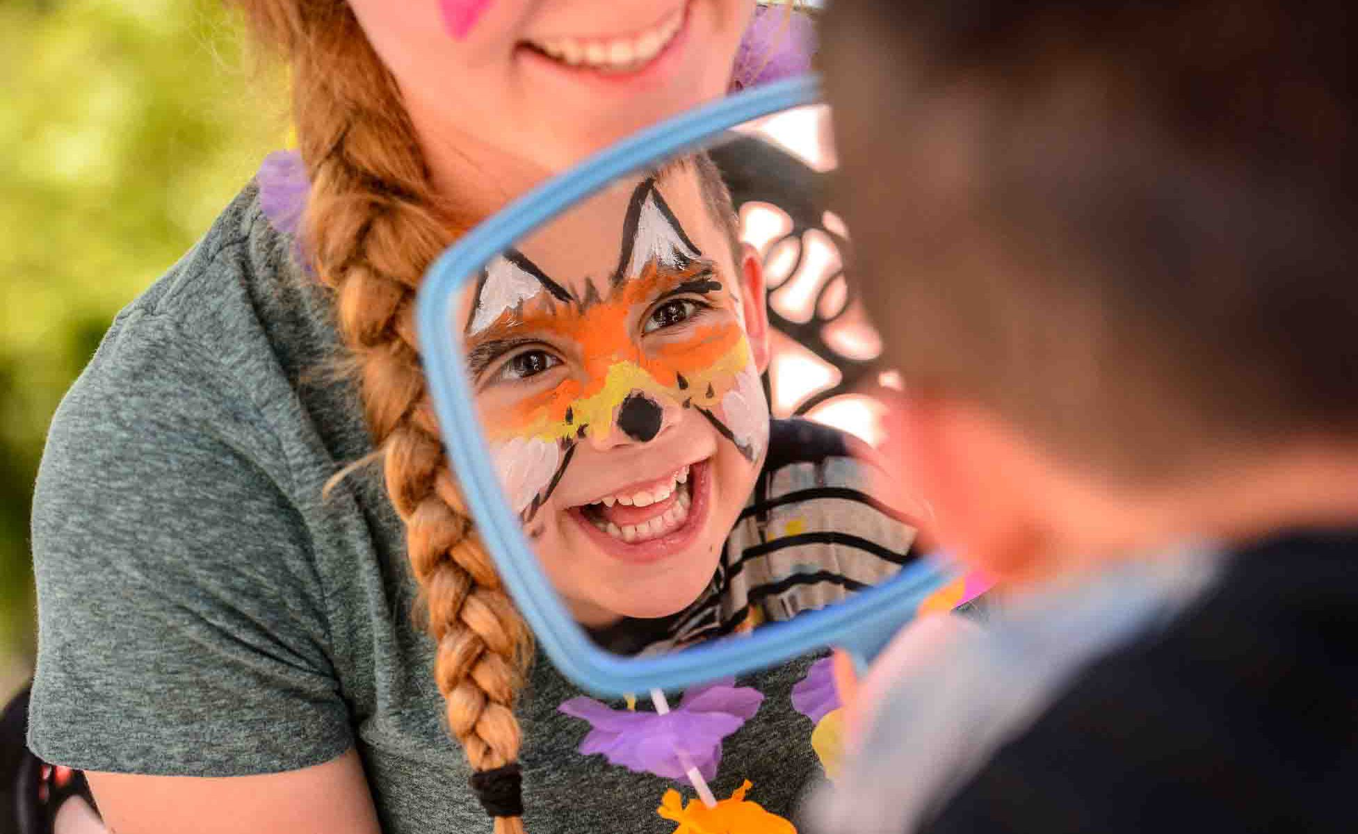 Trent Nelson  |  The Salt Lake Tribune
Troy Fryer, 6, tests out his face painting (a fox) at Westminster College’s Tenth Annual Family Fun Day for children with autism and their families, in Salt Lake City, Saturday June 3, 2017. Rachel Kuhr, at rear, is the artist.
