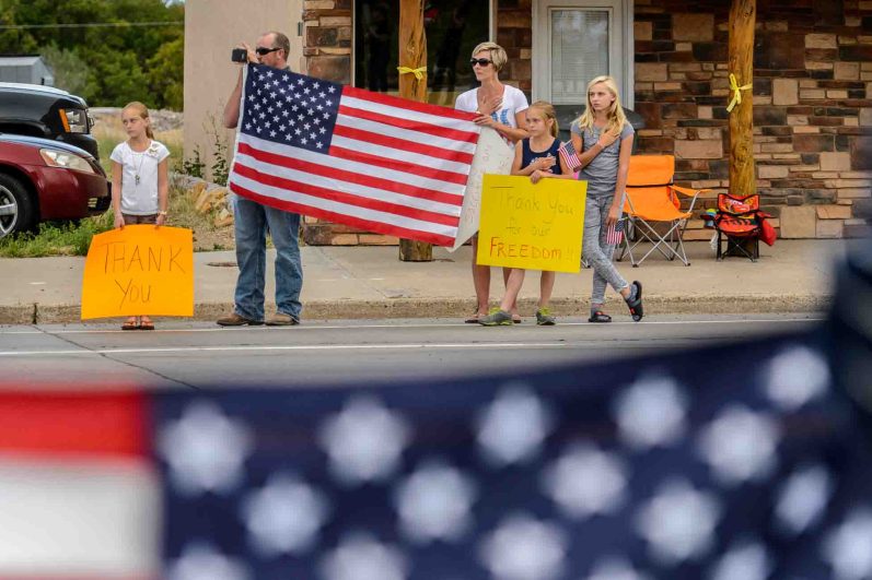 (Trent Nelson | The Salt Lake Tribune)  Crowds line Main Street in Monticello to honor the motorcade of fallen soldier Aaron Butler, who was killed last week in Afghanistan, , Thursday August 24, 2017.