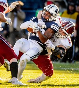 (Trent Nelson | The Salt Lake Tribune)  Brigham Young Cougars defensive back Michael Shelton (18) is tackled by Massachusetts Minutemen defensive lineman Joe Previte (61) as BYU hosts the University of Massachusetts, NCAA football in Provo, Saturday November 18, 2017.