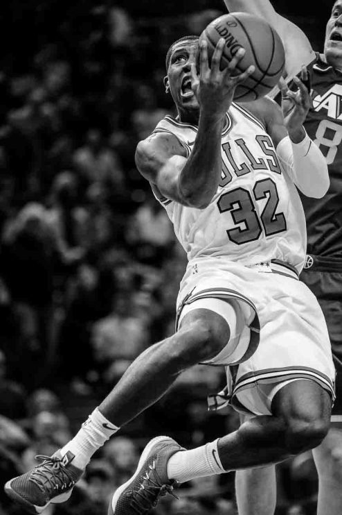 Chicago Bulls guard Kris Dunn (32) goes up for a shot, with Utah Jazz forward Jonas Jerebko (8) behind, as the Utah Jazz host the Chicago Bulls, NBA basketball in Salt Lake City Wednesday November 22, 2017.