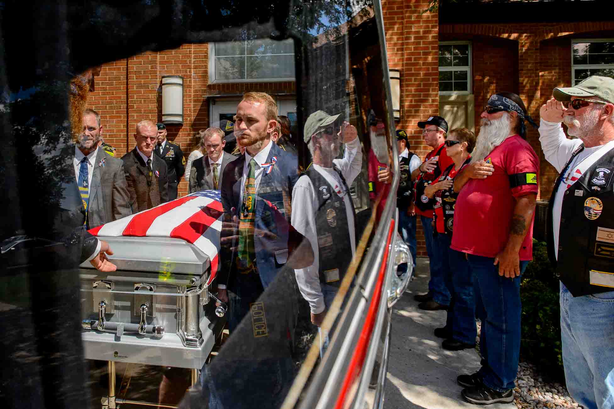 (Trent Nelson | The Salt Lake Tribune)  Pallbearers at the funeral for fallen soldier Aaron Butler, in Monticello Saturday August 26, 2017. At right are members of the Patriot Guard Riders.