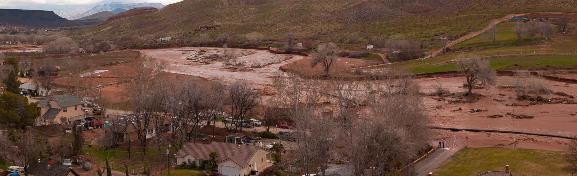 People watching the overflowing Santa Clara River washing away roads and homes, flood in southern utah