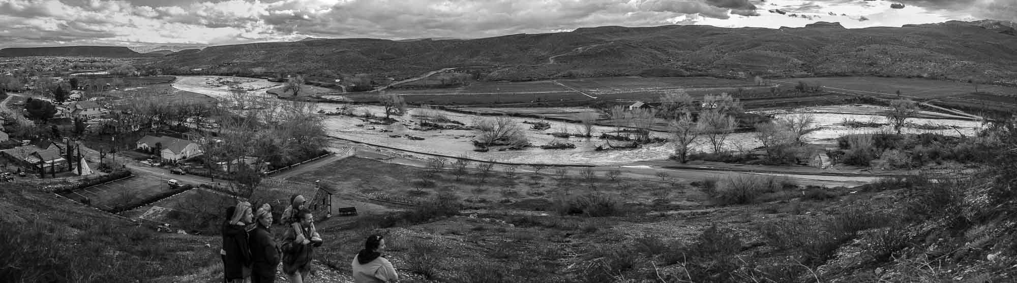 People watching the overflowing Santa Clara River washing away roads and homes, flood in southern utah