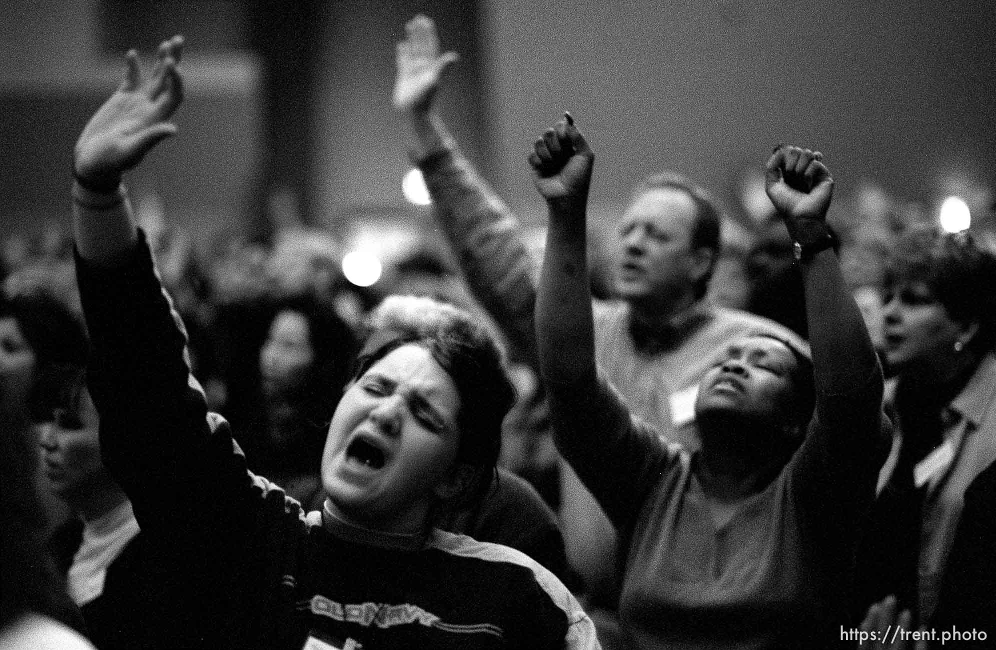 Darby Nelson praises God at a Penecostal meeting Thursday night at Judge High School.