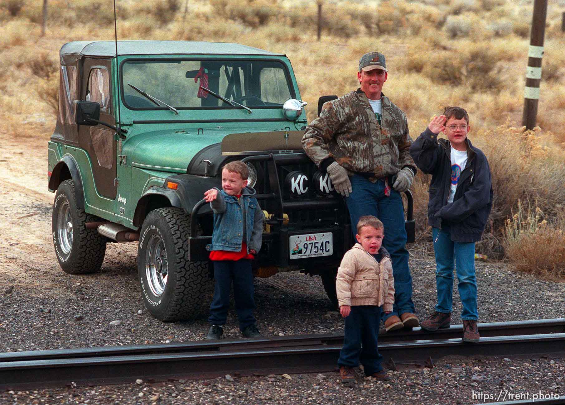 Father, jeep and sons waves to the Governor's Centennial Train