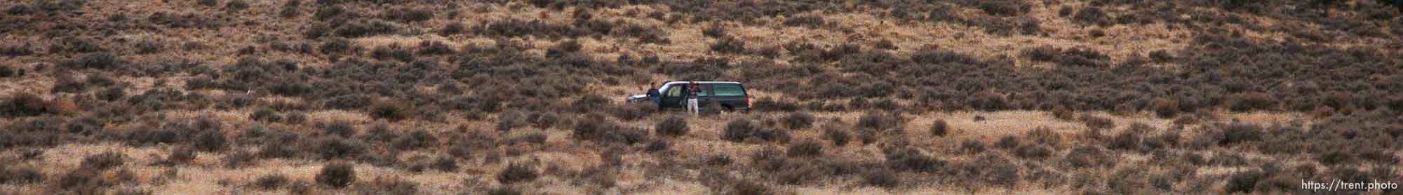 People in the middle of nowhere wave to the Governor's Centennial Train