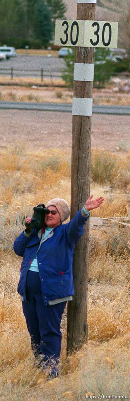 Woman films and waves to the Governor's Centennial Train