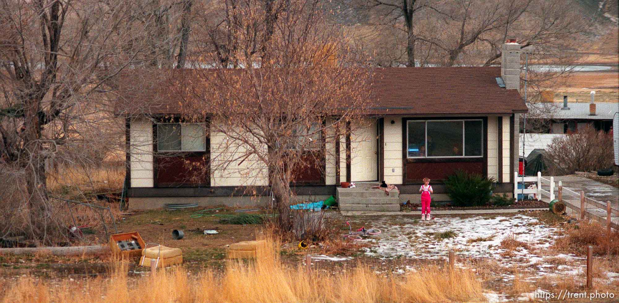 Child outside her home, watching the Governor's Centennial Train