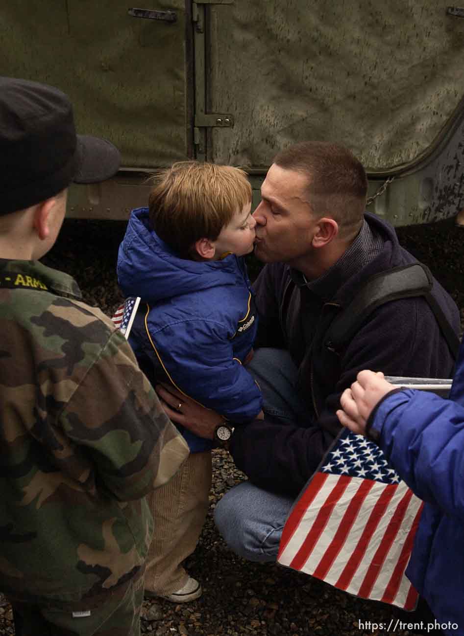 Major John Hanson kisses his son, Walker, as he leaves for the war in Iraq. The 1457th Engineer Combat Battalion of the Utah Army National Guard deployed approximately 500 soldiers Thursday. A large number of family members and friends turned out for the emotional and somber farewell.; 02.13.2003, 1:25:31 PM