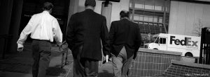 Three businessmen walking at lunch time.