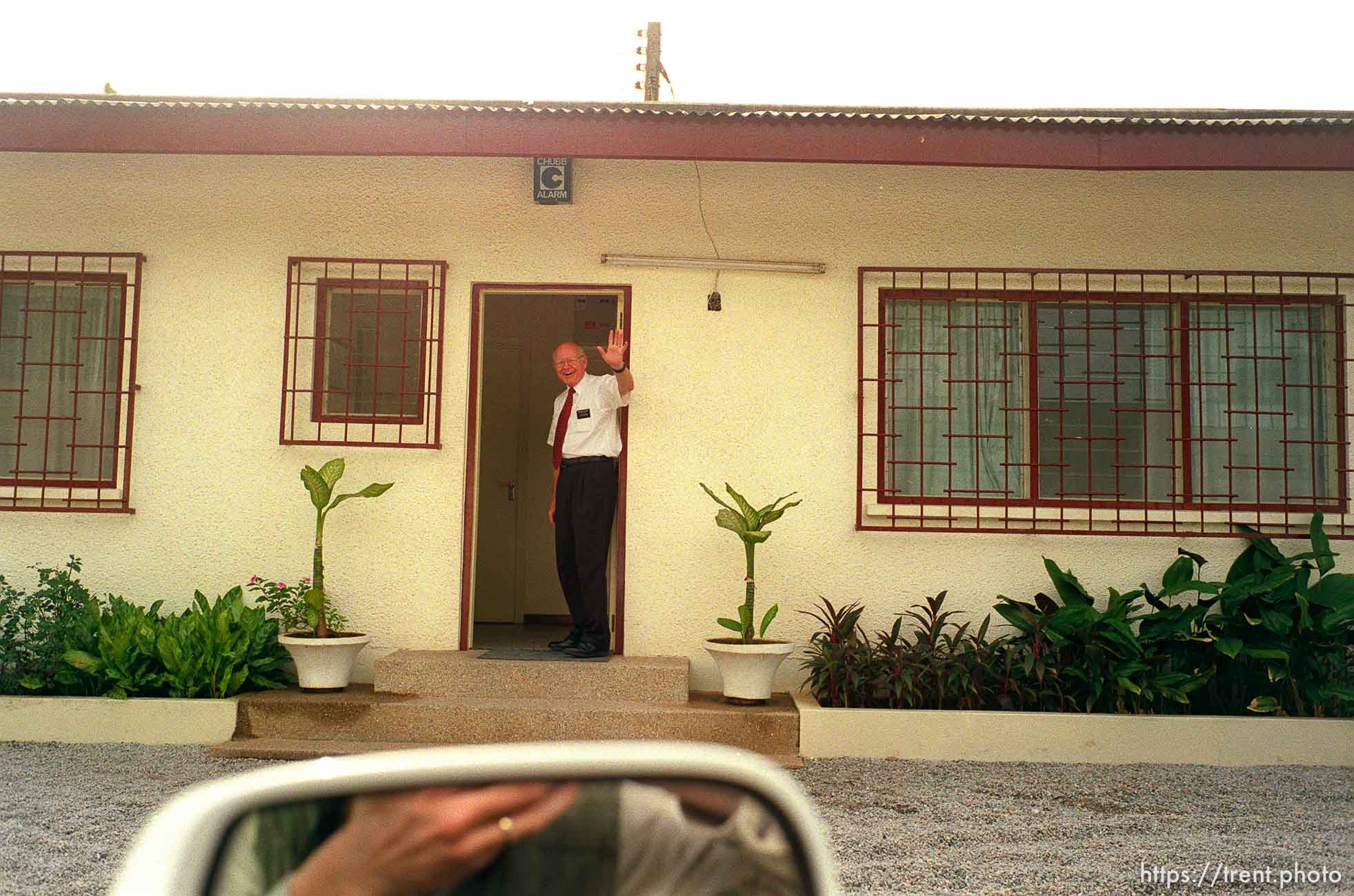 President of the Ghana LDS mission Larry Bodhaine waves from the entrance of the mission home.