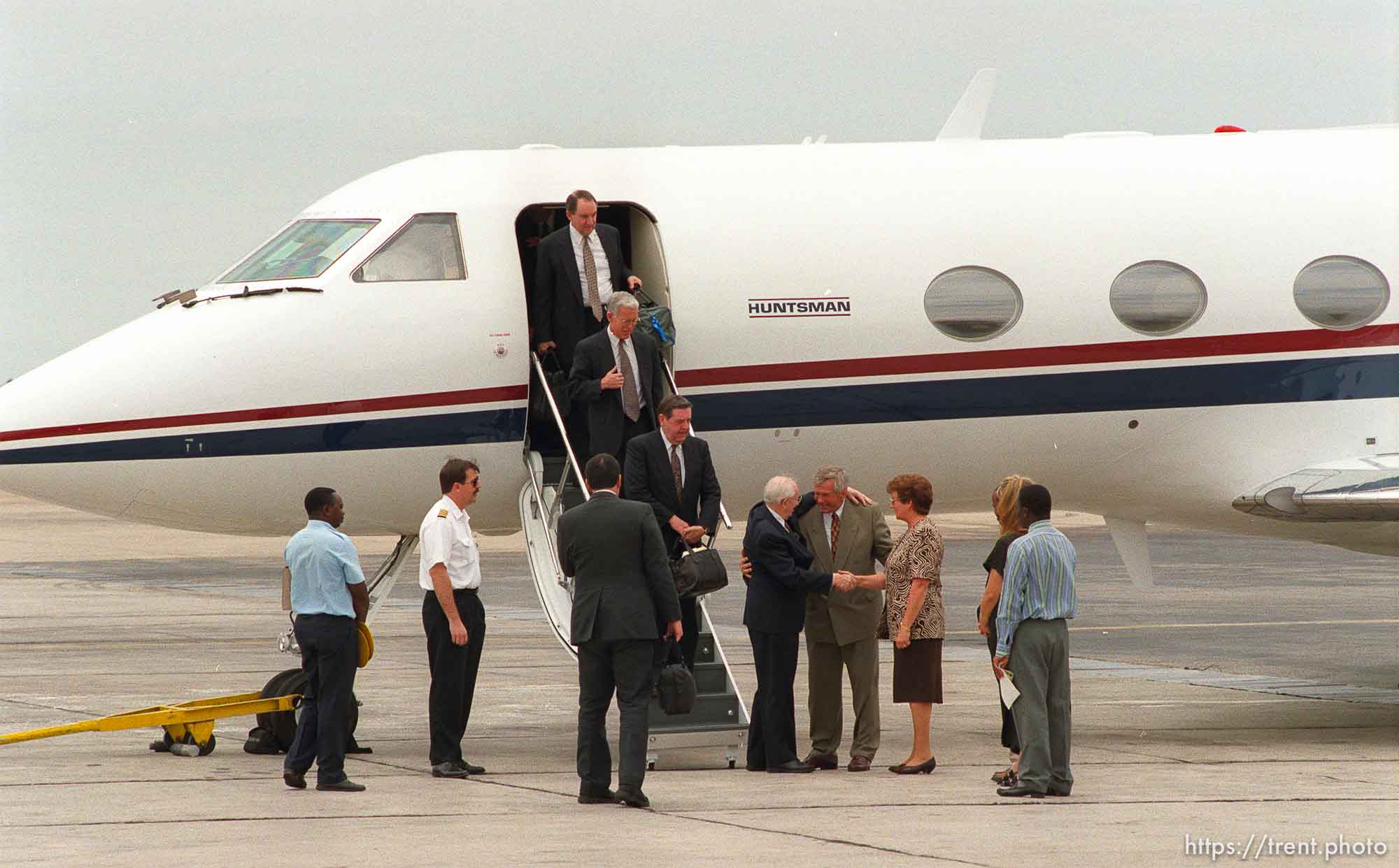 LDS President Gordon B. Hinckley arrives at the Harare airport. Reg Nield and his wife Iris greet them.