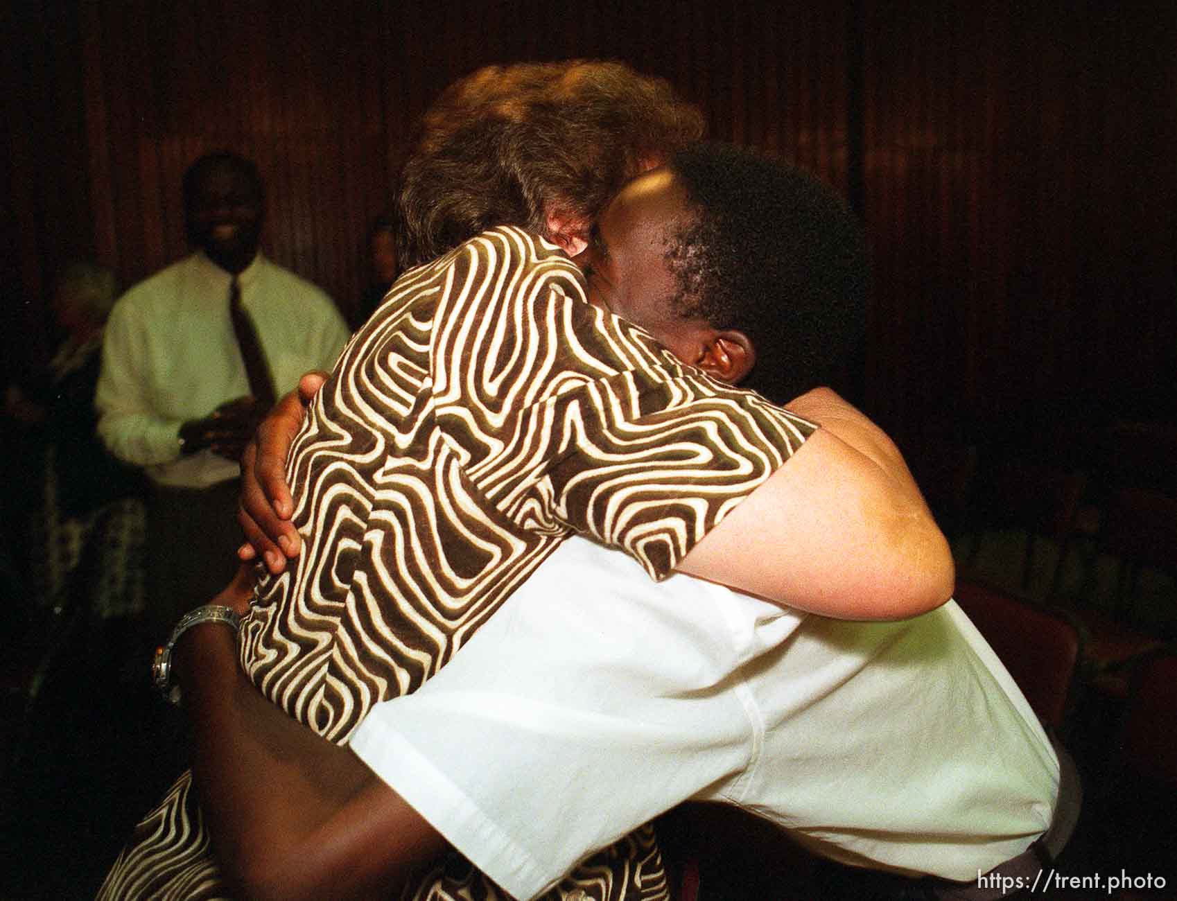 Iris Nield hugs Taurai Chatora after LDS Prophet Gordon B. Hinckley spoke in the Zuna PF Building.