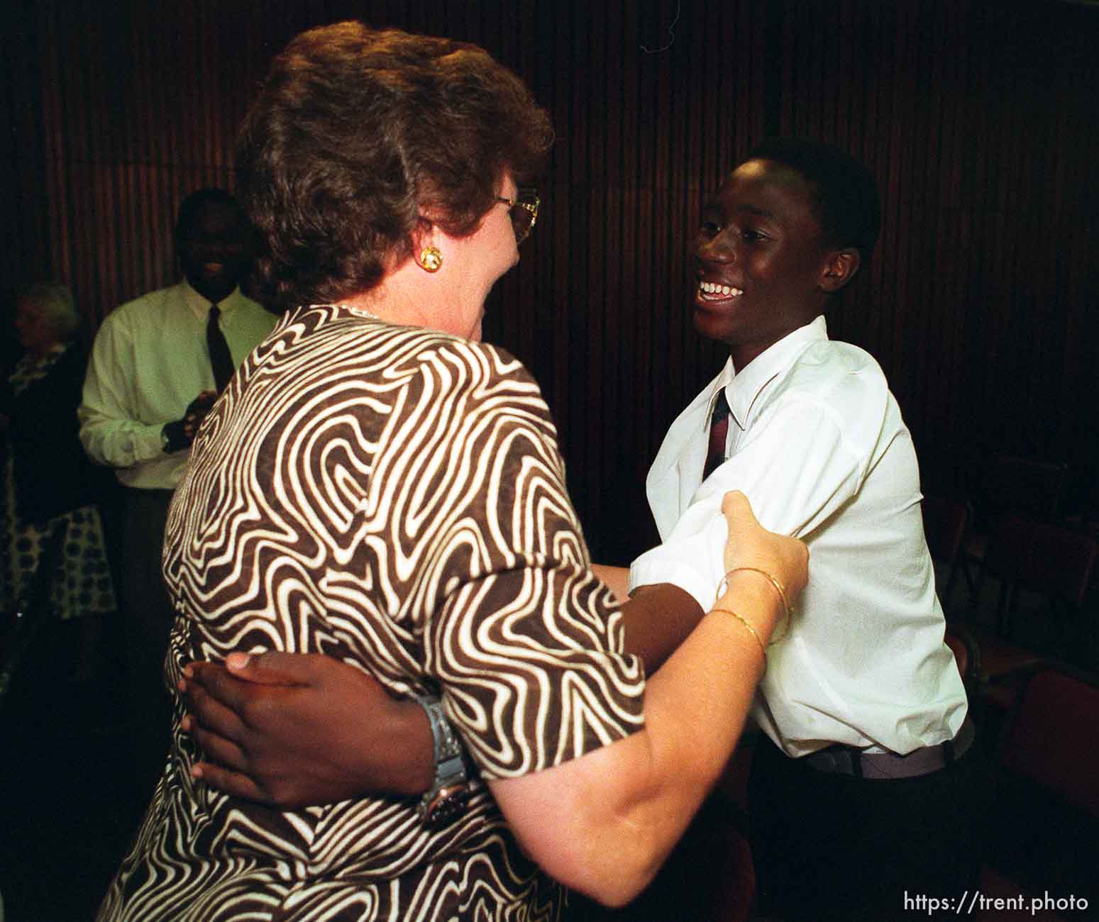 Iris Nield hugs Taurai Chatora after LDS Prophet Gordon B. Hinckley spoke in the Zuna PF Building.