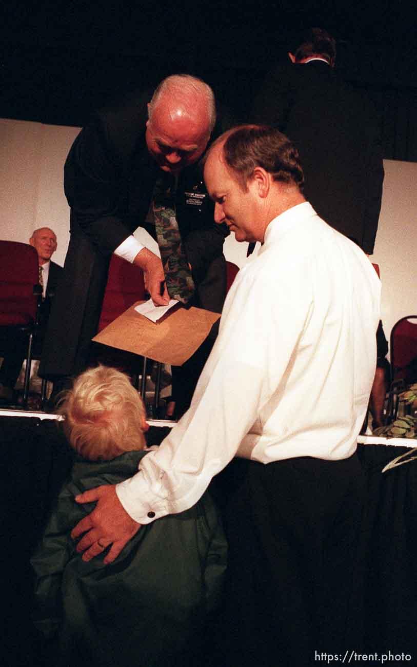 6-year-old Ben Stabbert gives former Utah Governor and current mission president Norm Bangerter a letter to pass to LDS president Gordon B. Hinckley. Andre Bester in white shirt.