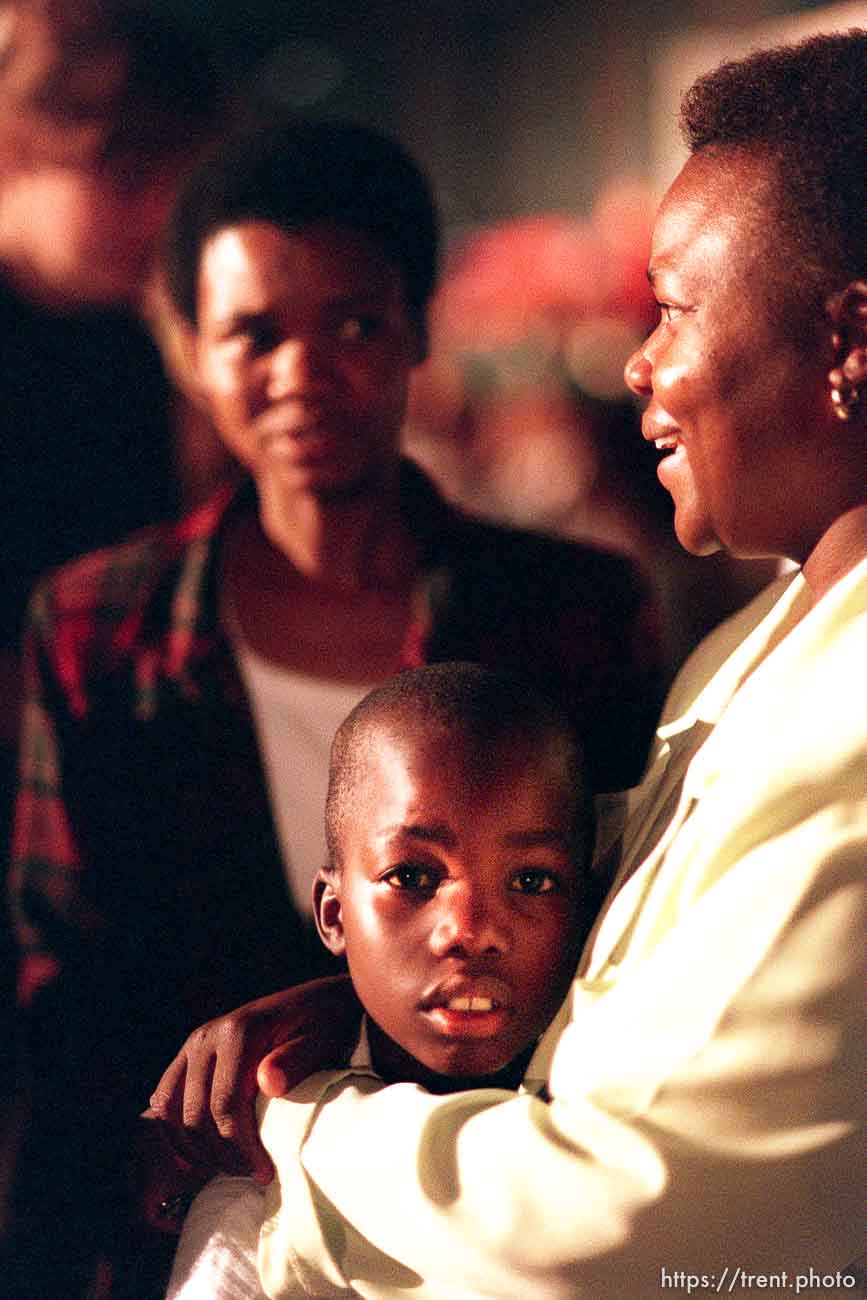 left to right: Selina Kekana, John Mathipa (8), and his mother Lesbrina Mathipa at a meeting where LDS president Gordon B. Hinckley spoke.