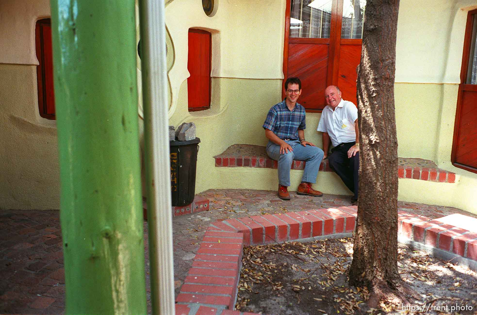 Nigel Giddey, branch president of the Guguletu LDS ward in an open-air courtyard that often serves as a place to conduct ecclesiastical interviews. At right is Clive Nicholls.