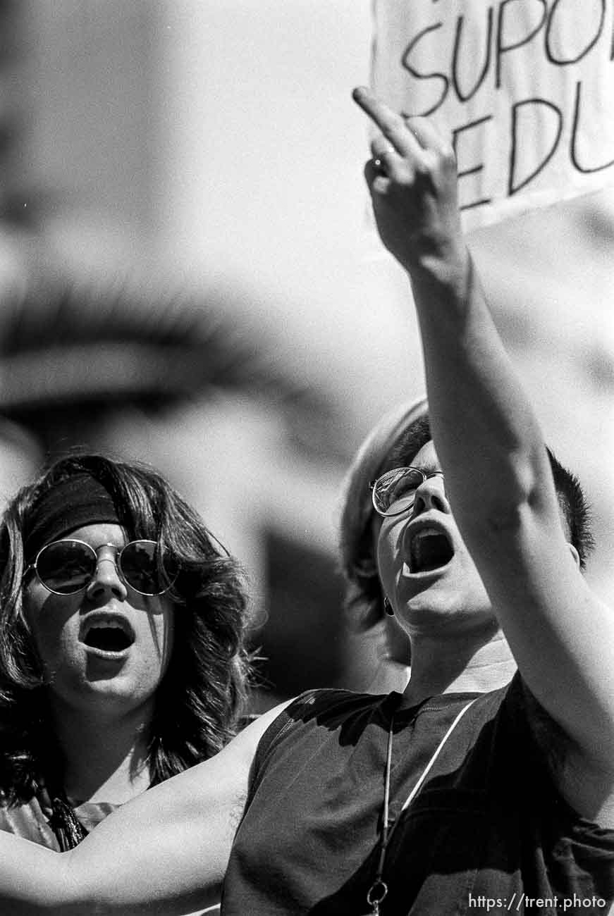 Woman flips off police at Act-Up protest during visit of President Bush