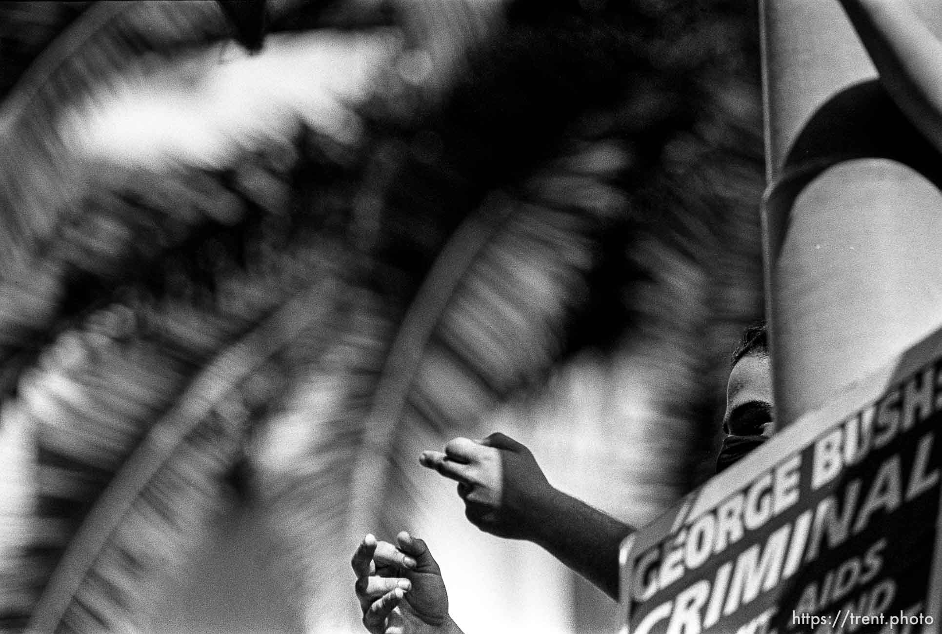 Person flipping off police at Act-Up protest during visit of President Bush