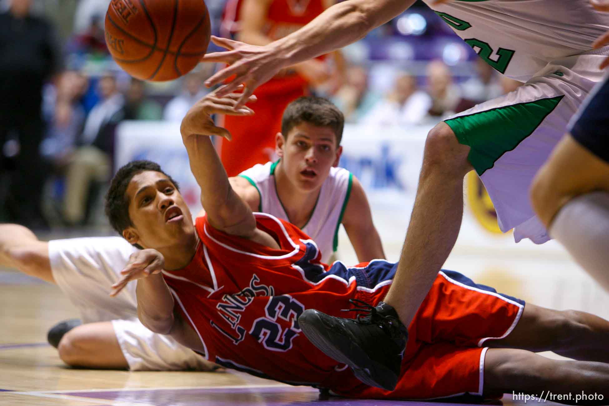 Ogden - Granger's T. J. Tapusoa tries to get the ball from the floor to a teammate. Provo's Scott Edwards at rear. Provo vs. Granger High School boys basketball, 4A State Basketball Championships at the Dee Events Center Wednesday.