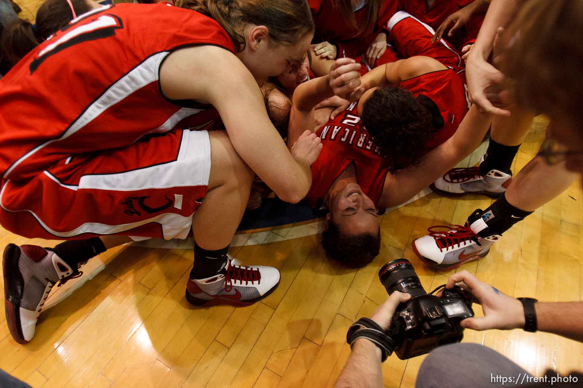 Taylorsville - American Fork players collapse in a dog pile at center court, celebrating their championship win over Riverton. Riverton vs. American Fork High School girls basketball, 5A State Championship game Saturday February 28, 2009 at Salt Lake Community College.
craig dilger