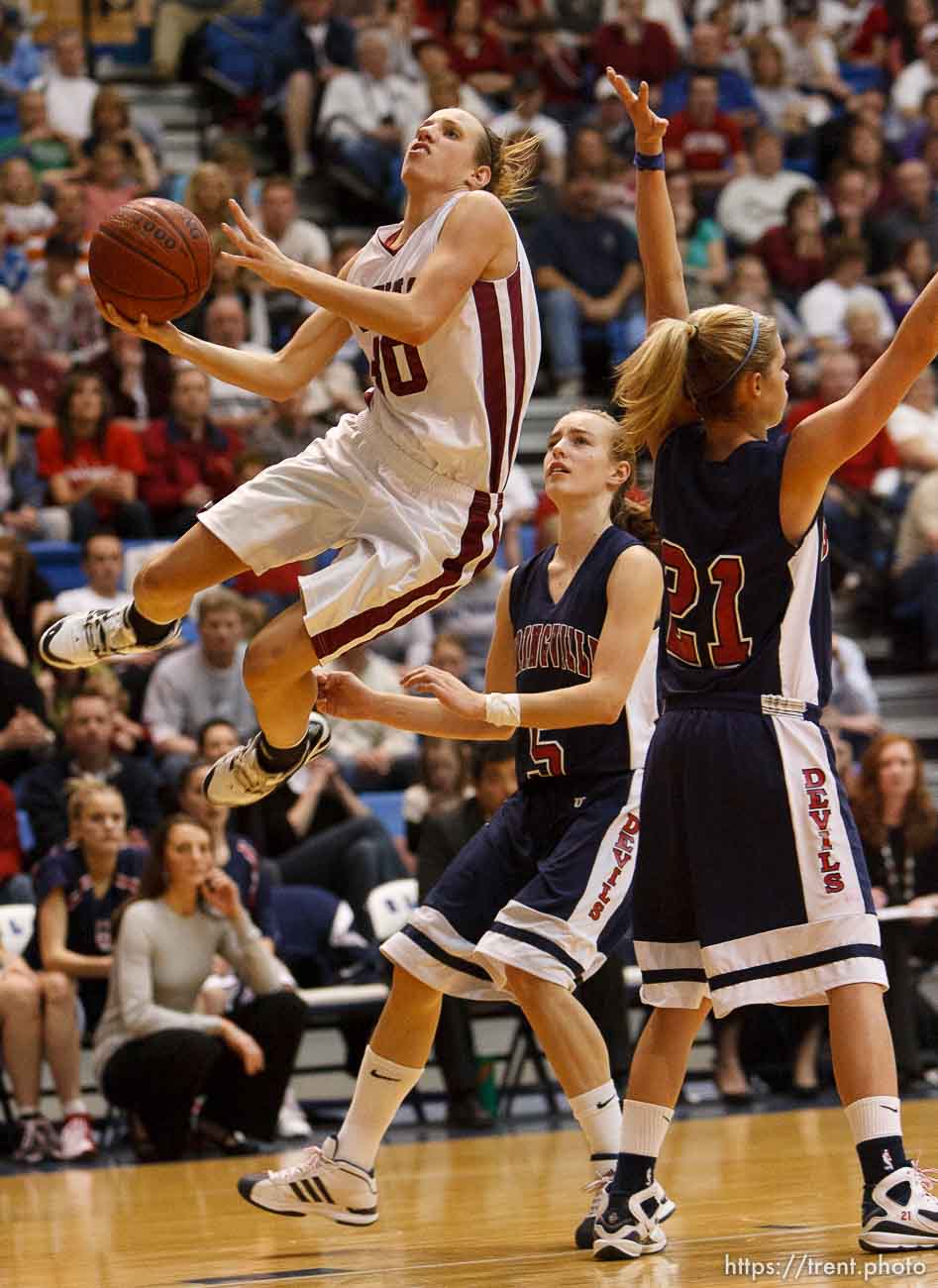 Taylorsville - Mountain View's Anjie Lines (30) goes airborne and hscores, with Springville's Lexi Eaton (5) and Springville's Ashley Kroneberger (21) defending. Mountain View vs. Springville High School girls basketball, 4A State Championship game Saturday February 28, 2009 at Salt Lake Community College.