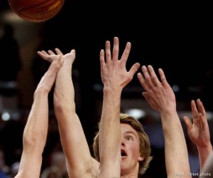 East's Preston Curtis shoots over Olympus' Coulson Hardy, left, and Will Cannon. East vs. Olympus, 4A High School Basketball Championships Wednesday, February 29, 2012 at the Maverik Center in West Valley City, Utah.