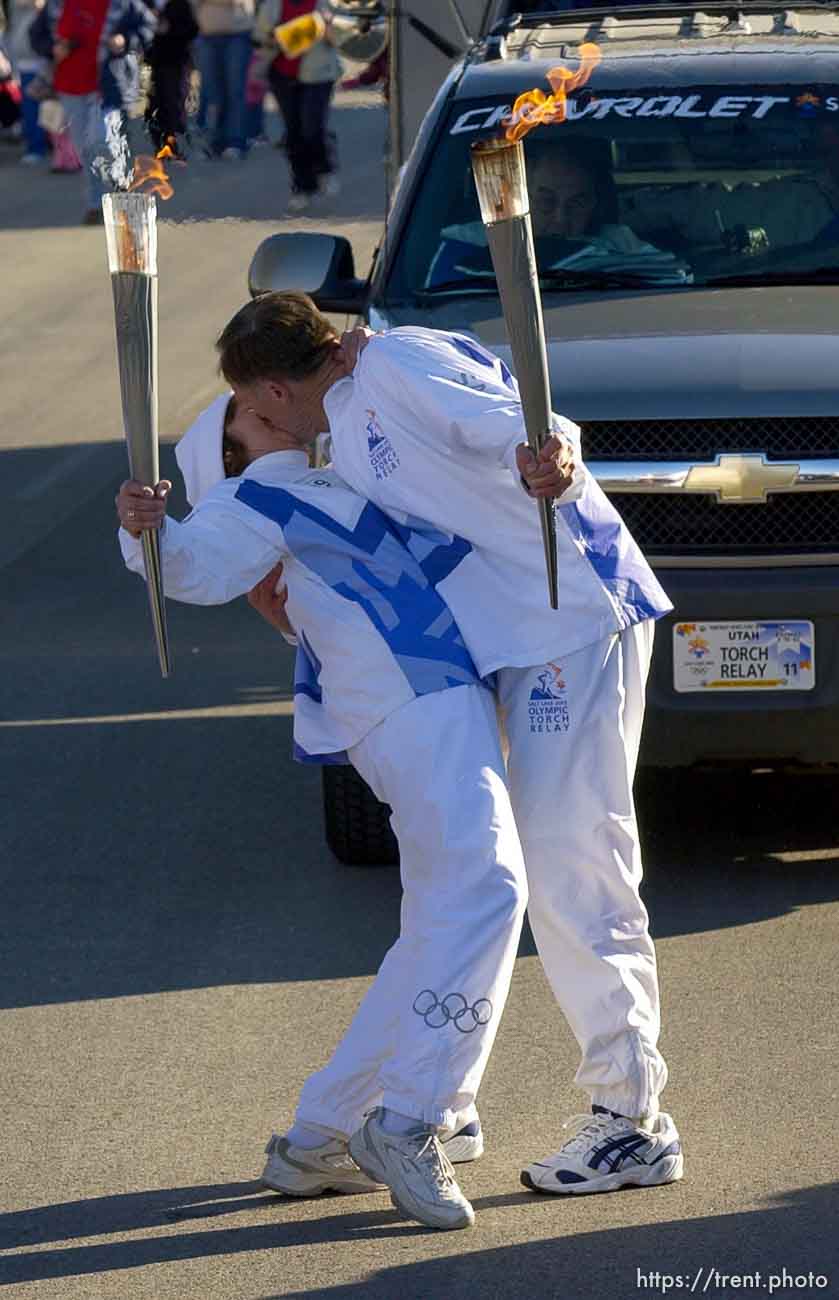 The Olympic Torch Relay arrives on Main Street in Manti Tuesday afternoon. Torchbearer Leonard Moon runs brimming with excitement, and then gives his wife Delores a back-bending kiss as she takes her turn as the next torchbearer in the schedule.
 02.05.2002, 3:56:12 PM