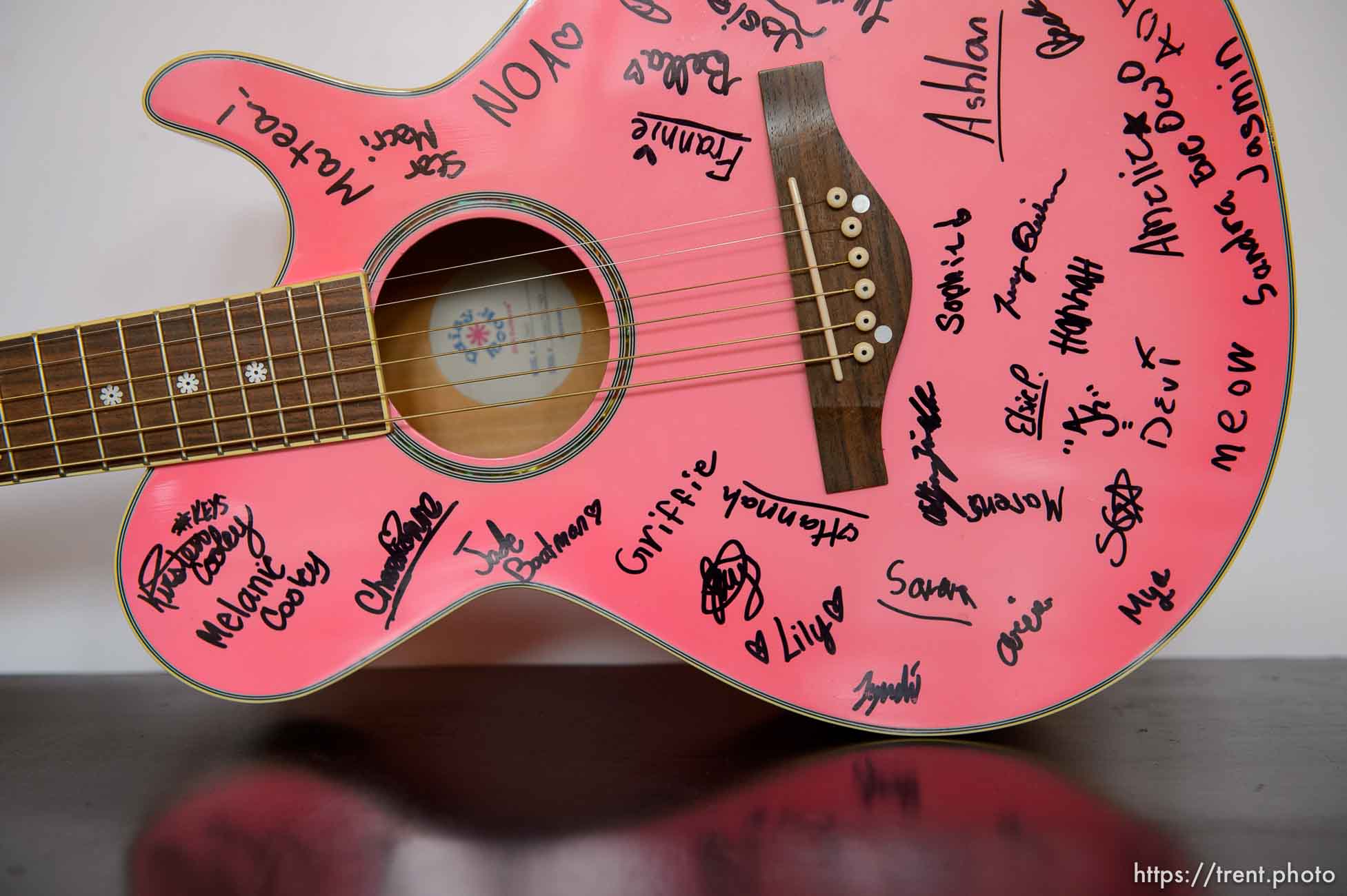 An autographed pink guitar at Rock Camp for Womyn. People attending the camp learn how to play instruments, form bands, write songs, and perform live in concert — all in three days. It's a new program by the same group that does Rock and Roll Camp for Girls. Salt Lake City, Friday February 2, 2018.